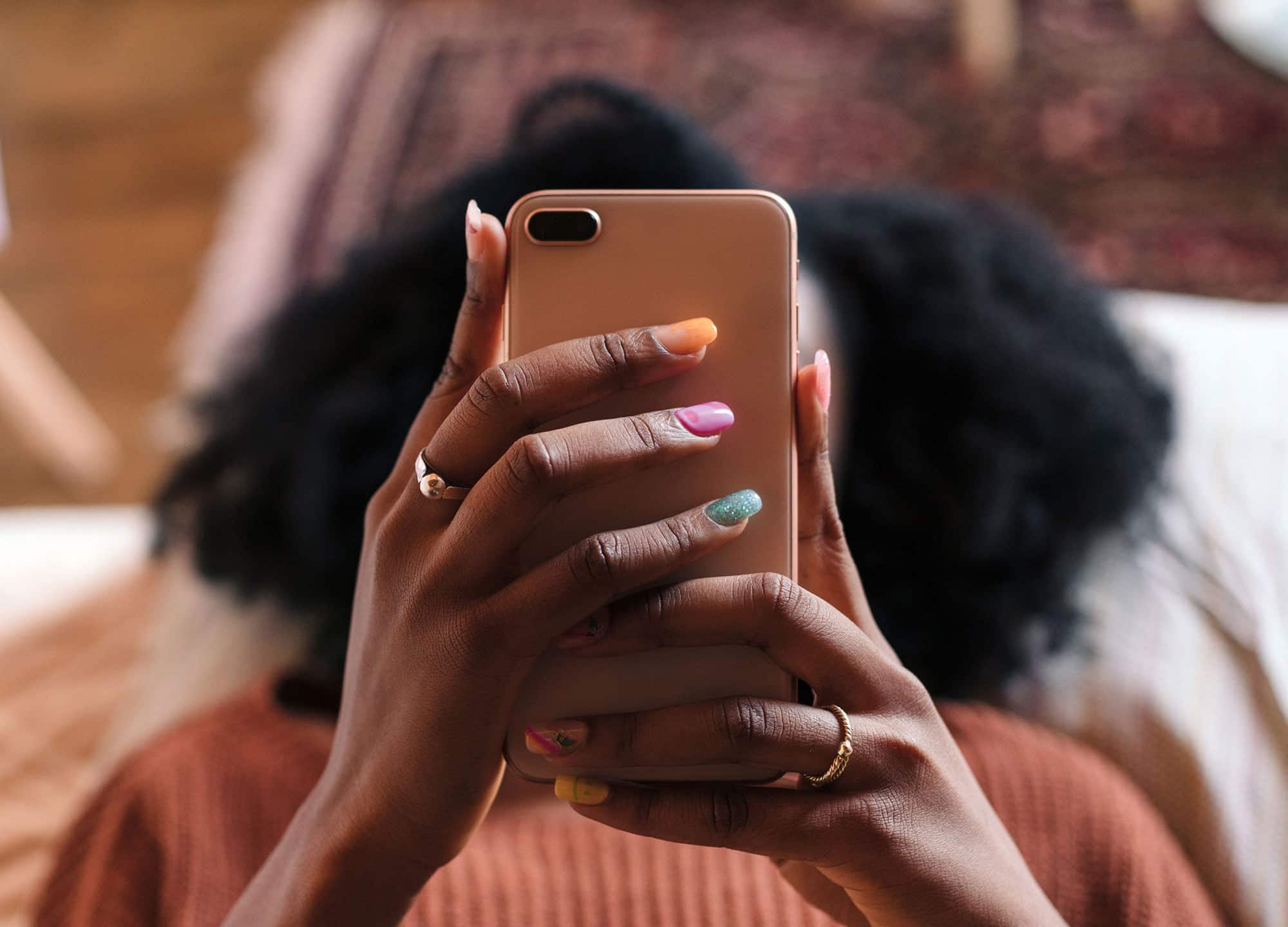 Woman laying down while looking at a phone
