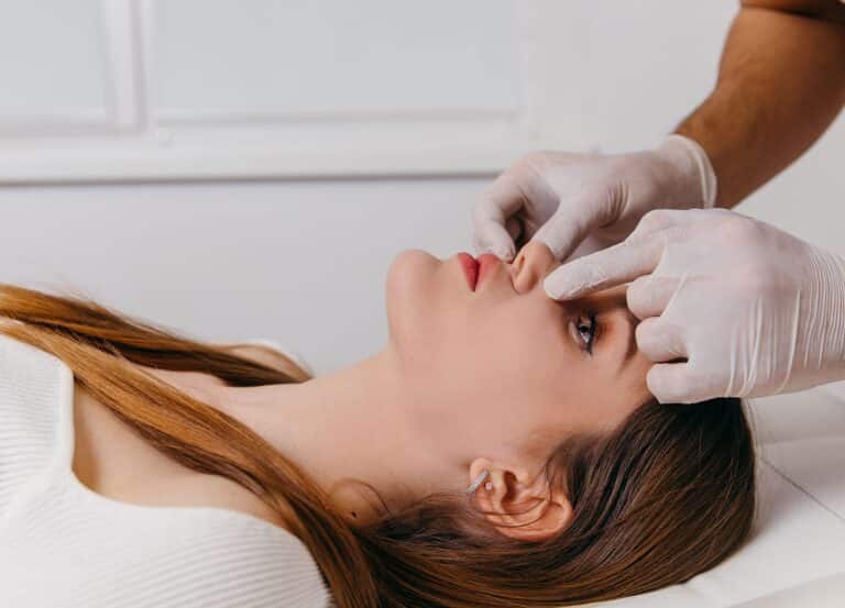 Doctor examining nose prior to rhinoplasty or nose augmentation