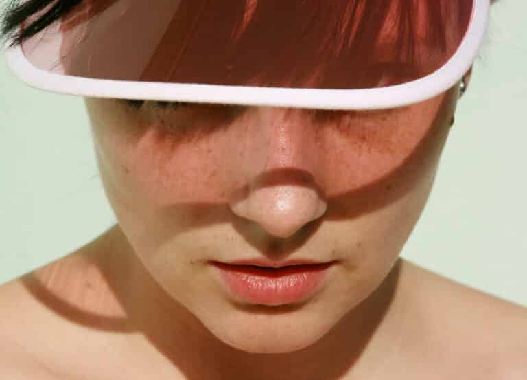 Woman wearing visor in the summer sun
